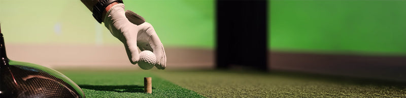 golf ball being placed on a golf tee